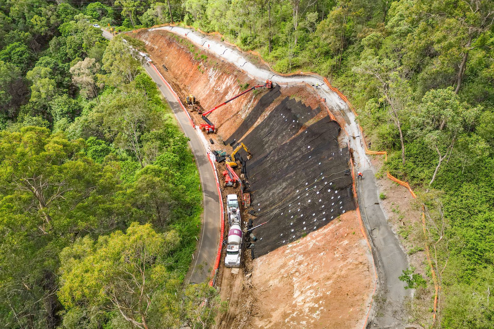 Aerial view of a sprayed batter and slope stabilisation works beside a range road