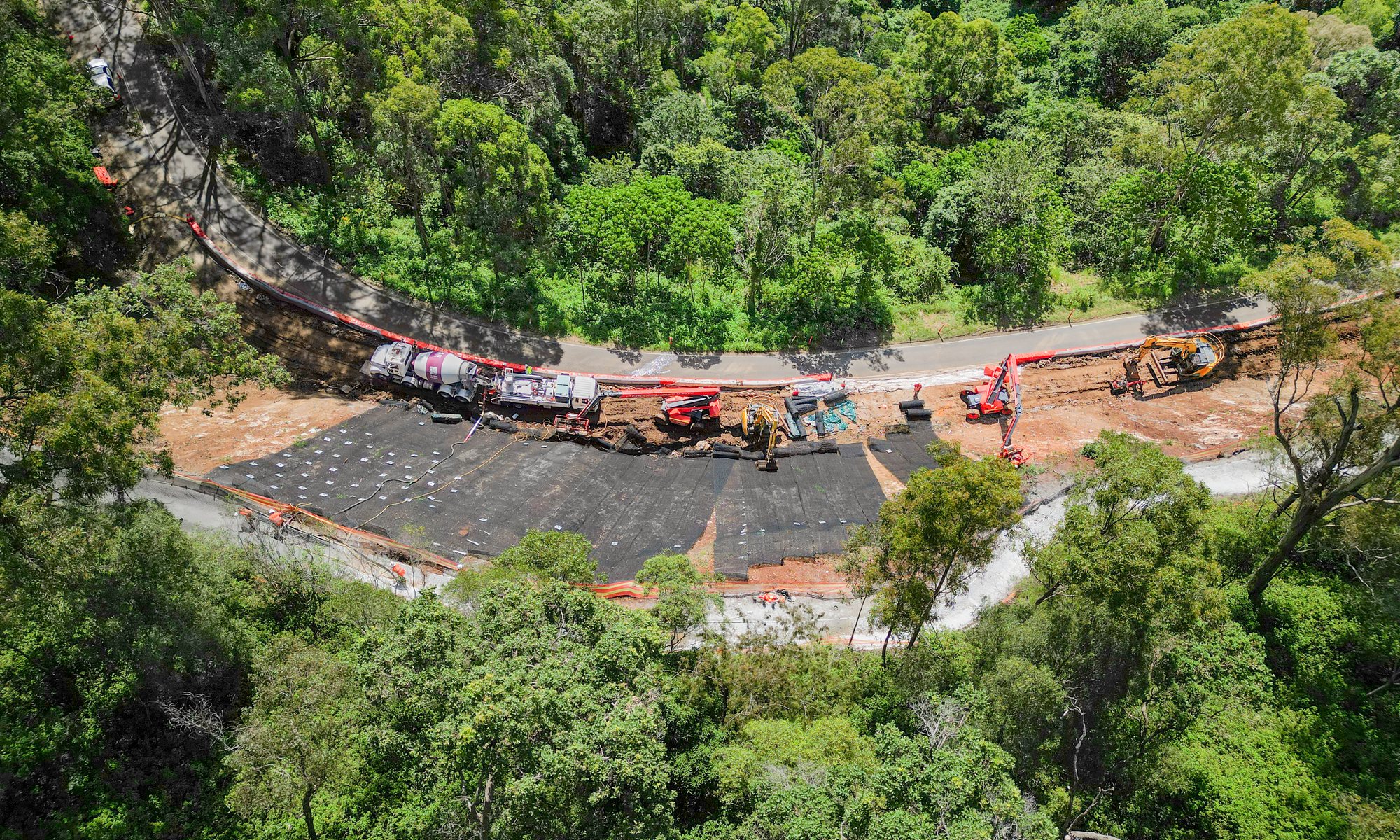 Aerial view of a long sprayed batter and stabilisation works on a Queensland range road