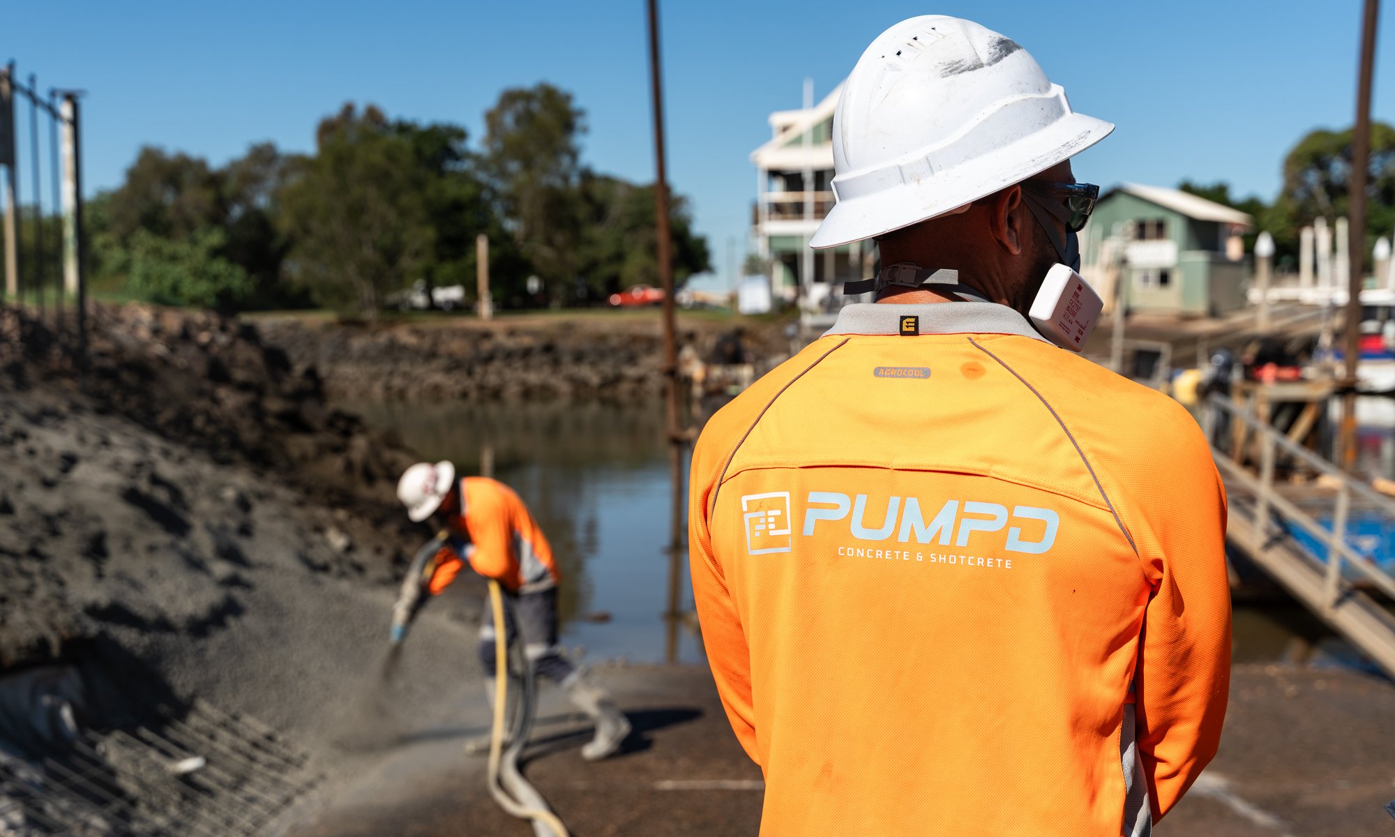 A Pumpd supervisor watching the crew place concrete on a waterfront site